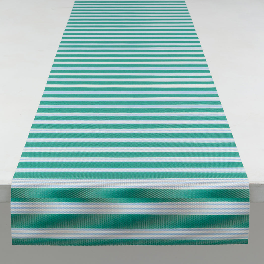 Chilewich striped woven mat with textured terrastrand yarn surface, featuring modern linear design and durable finish.
