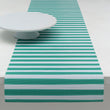 Chilewich striped woven mat with textured terrastrand yarn surface, featuring modern linear design and durable finish.