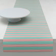 Chilewich striped woven mat with textured terrastrand yarn surface, featuring modern linear design and durable finish.
