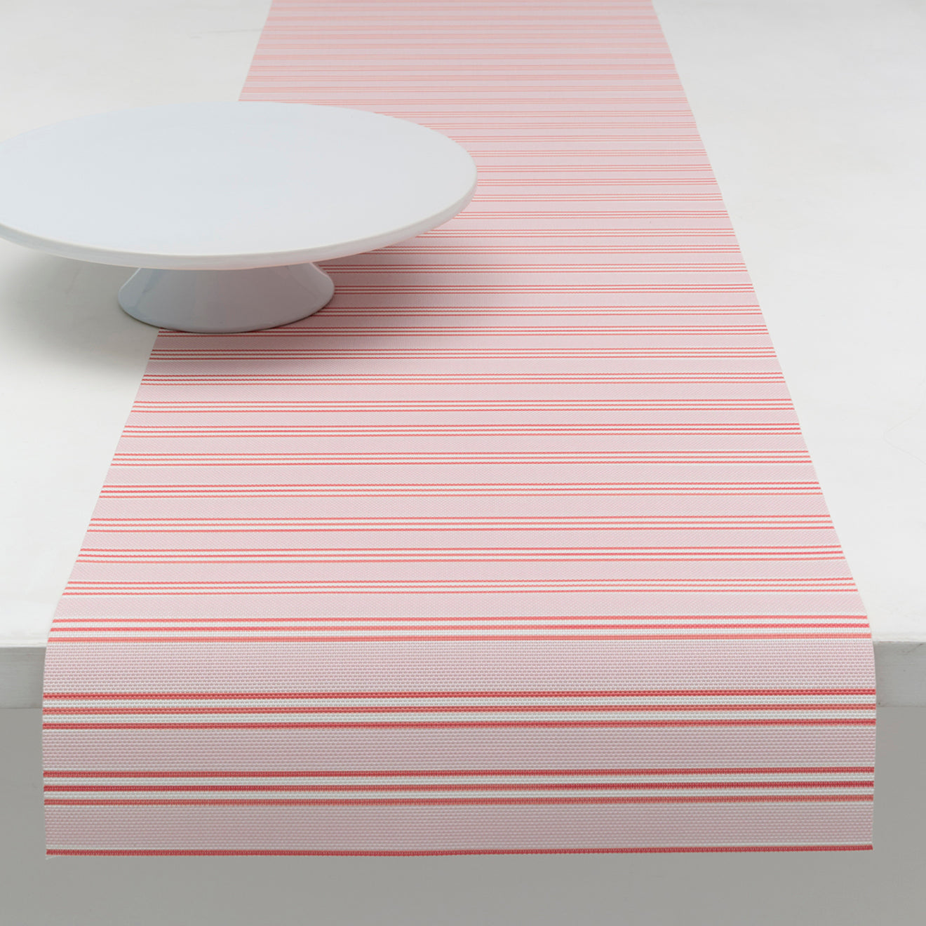 Chilewich striped woven mat with textured terrastrand yarn surface, featuring modern linear design and durable finish.