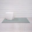 Chilewich striped woven mat with textured terrastrand yarn surface, featuring modern linear design and durable finish.