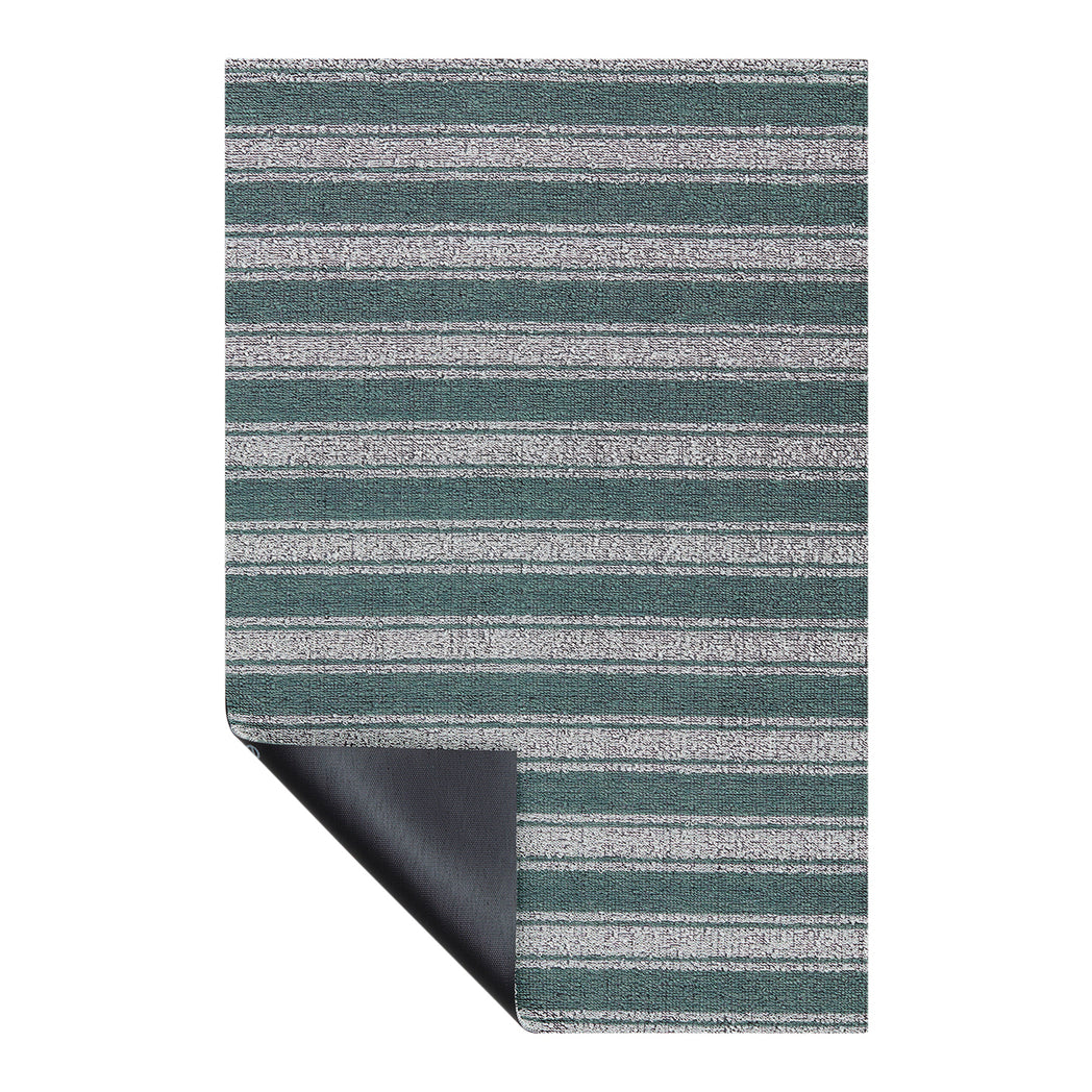 Chilewich striped woven mat with textured terrastrand yarn surface, featuring modern linear design and durable finish.