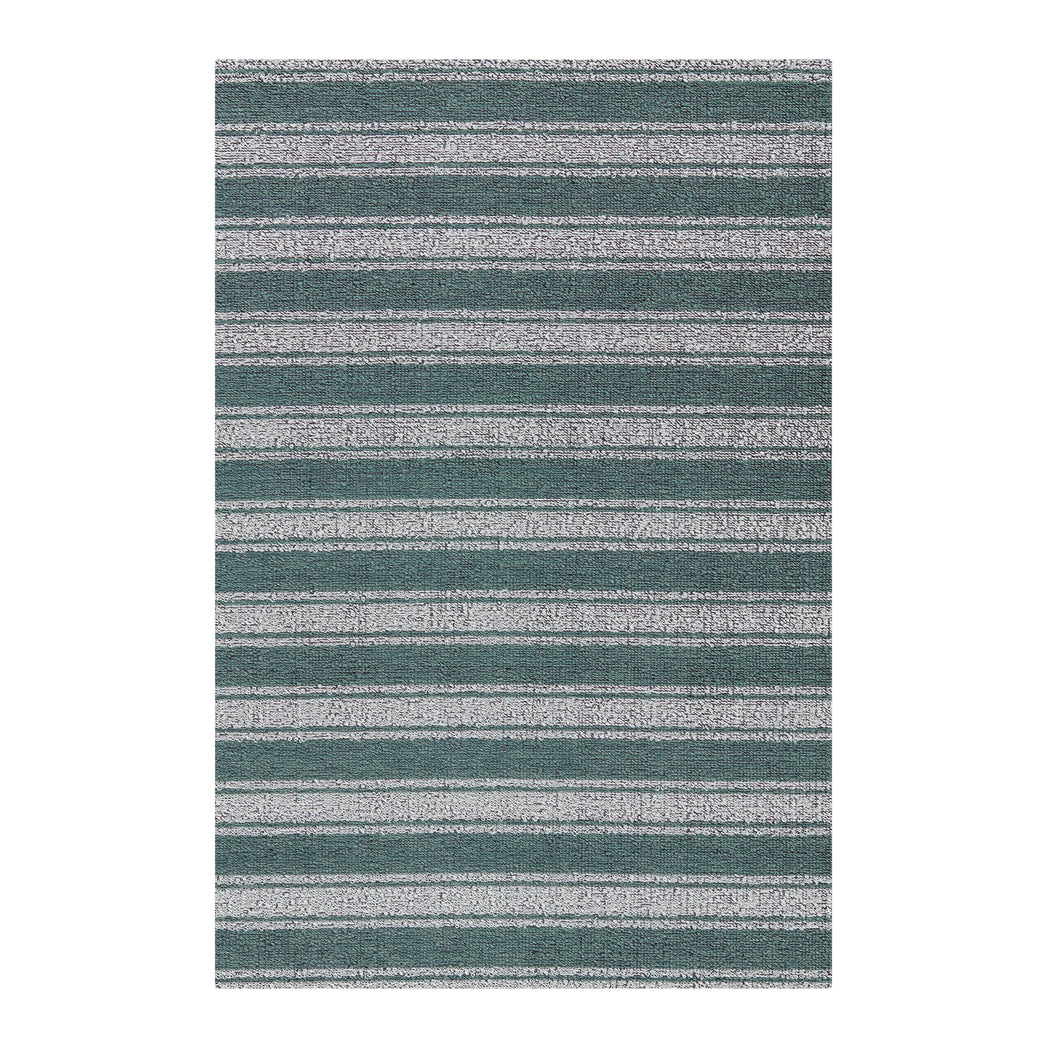 Chilewich striped woven mat with textured terrastrand yarn surface, featuring modern linear design and durable finish.