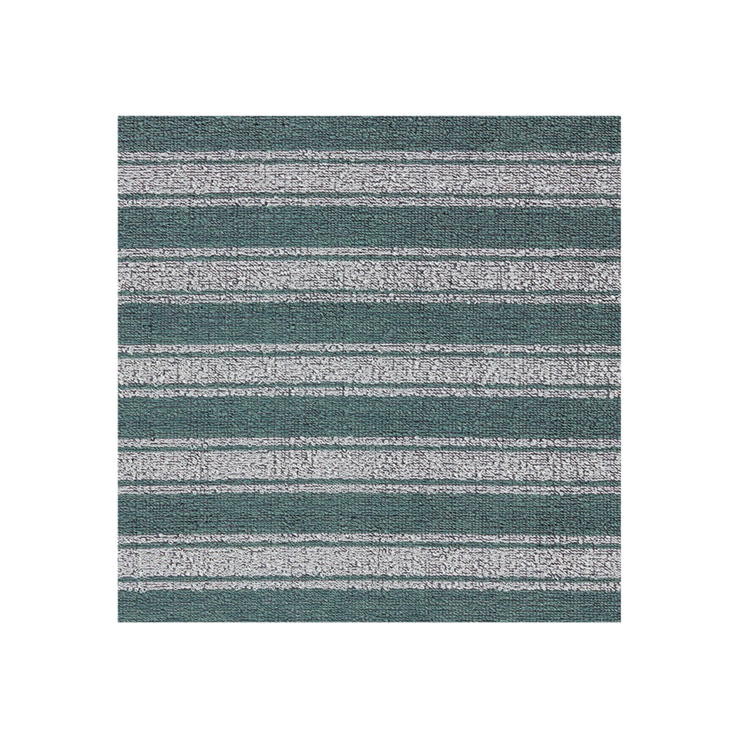 Chilewich striped woven mat with textured terrastrand yarn surface, featuring modern linear design and durable finish.