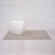 Chilewich striped woven mat with textured terrastrand yarn surface, featuring modern linear design and durable finish.