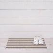 Chilewich striped woven mat with textured terrastrand yarn surface, featuring modern linear design and durable finish.