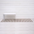 Chilewich striped woven mat with textured terrastrand yarn surface, featuring modern linear design and durable finish.
