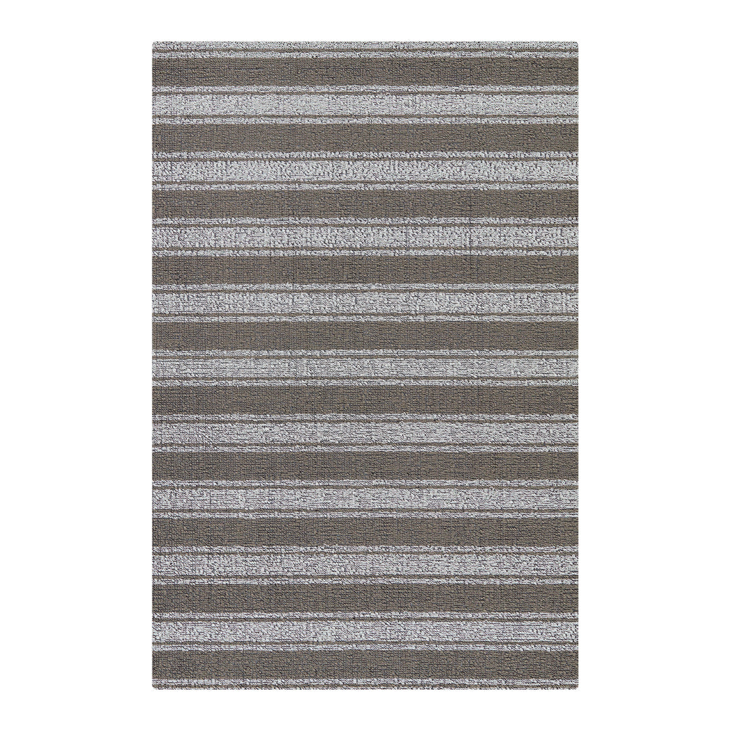 Chilewich striped woven mat with textured terrastrand yarn surface, featuring modern linear design and durable finish.