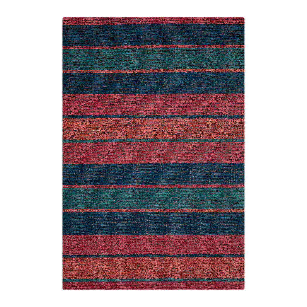 Chilewich striped woven mat with textured terrastrand yarn surface, featuring modern linear design and durable finish.