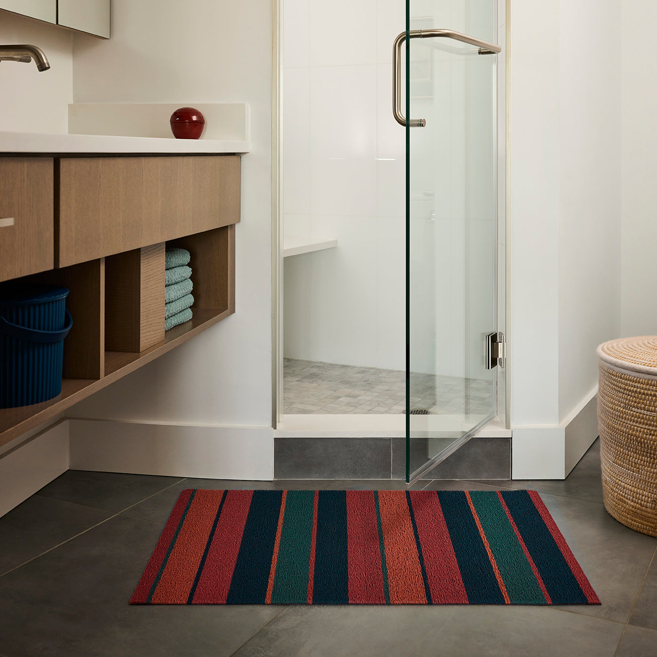 Chilewich striped woven mat with textured terrastrand yarn surface, featuring modern linear design and durable finish.