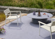 Outdoor patio setting with a round table and two chairs on a deck.