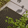 Chilewich striped woven mat with textured terrastrand yarn surface, featuring modern linear design and durable finish.