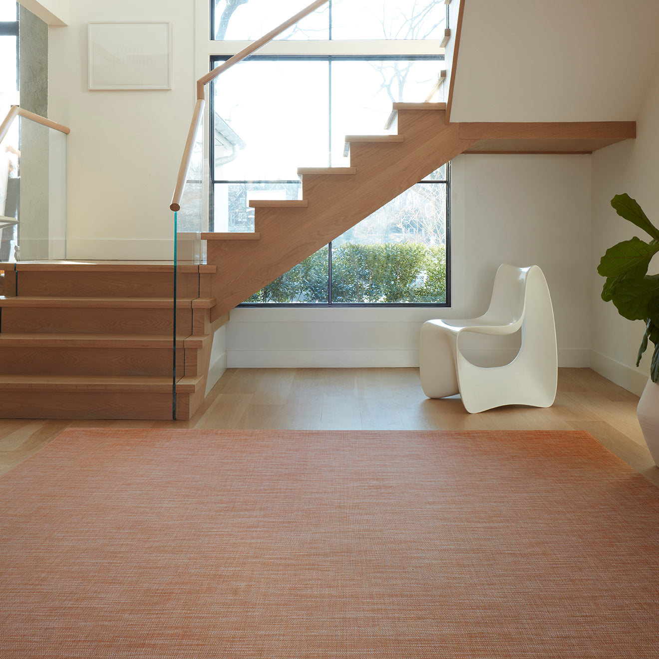 Chilewich Basketweave floor mat in Cinnamon, showcasing woven terrastrand yarn texture and modern design aesthetic.