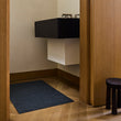 Chilewich woven floor mat in neutral woven terrastrand yarn, durable and stylish for modern living spaces.