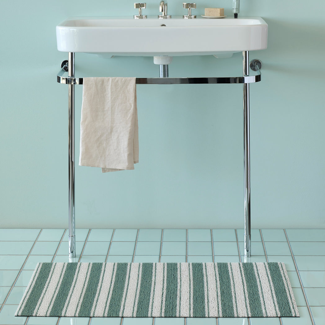 Chilewich striped woven mat with textured terrastrand yarn surface, featuring modern linear design and durable finish.