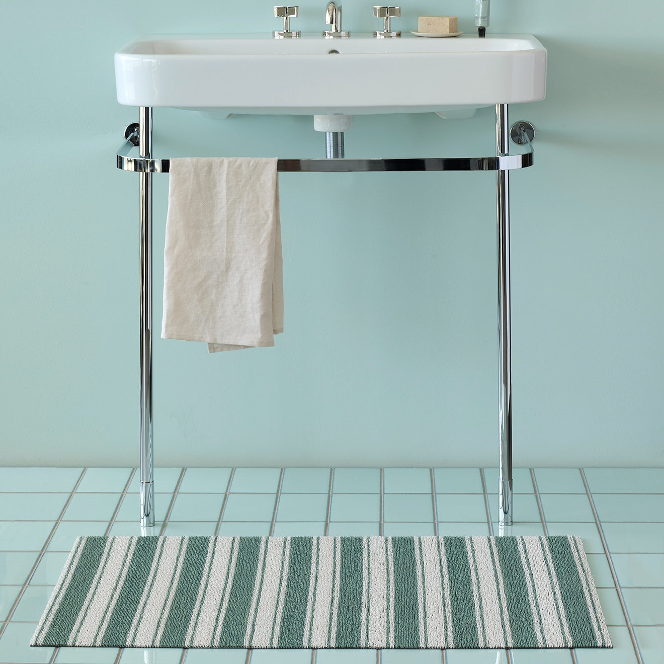 Chilewich striped woven mat with textured terrastrand yarn surface, featuring modern linear design and durable finish.