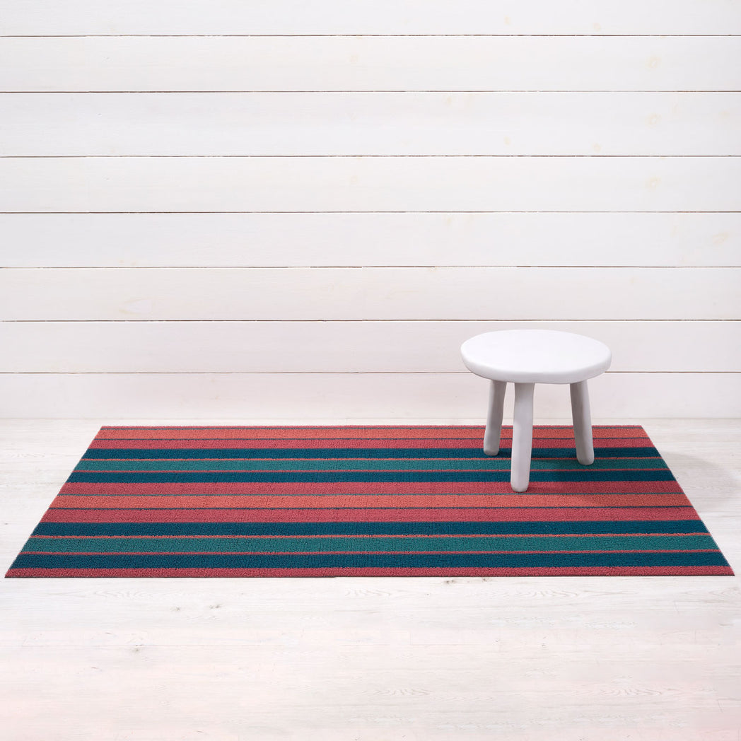 Chilewich striped woven mat with textured terrastrand yarn surface, featuring modern linear design and durable finish.