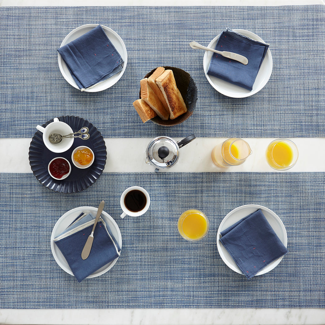 Chilewich Basketweave floor mat in Chambray, showcasing woven terrastrand yarn texture and modern design aesthetic.