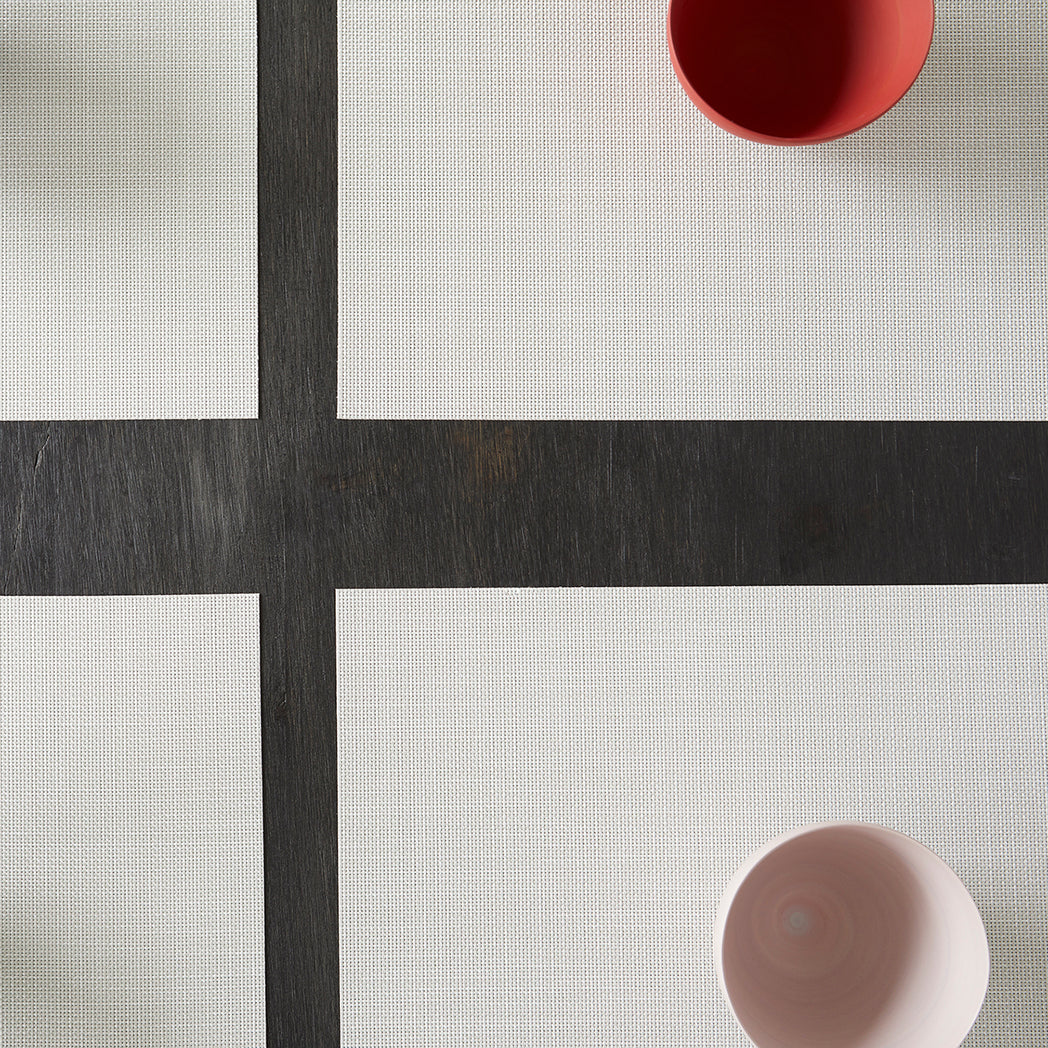 Chilewich Basketweave floor mat in Sandstone, showcasing woven terrastrand yarn texture and modern design aesthetic.