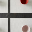 Chilewich Basketweave floor mat in Sandstone, showcasing woven terrastrand yarn texture and modern design aesthetic.
