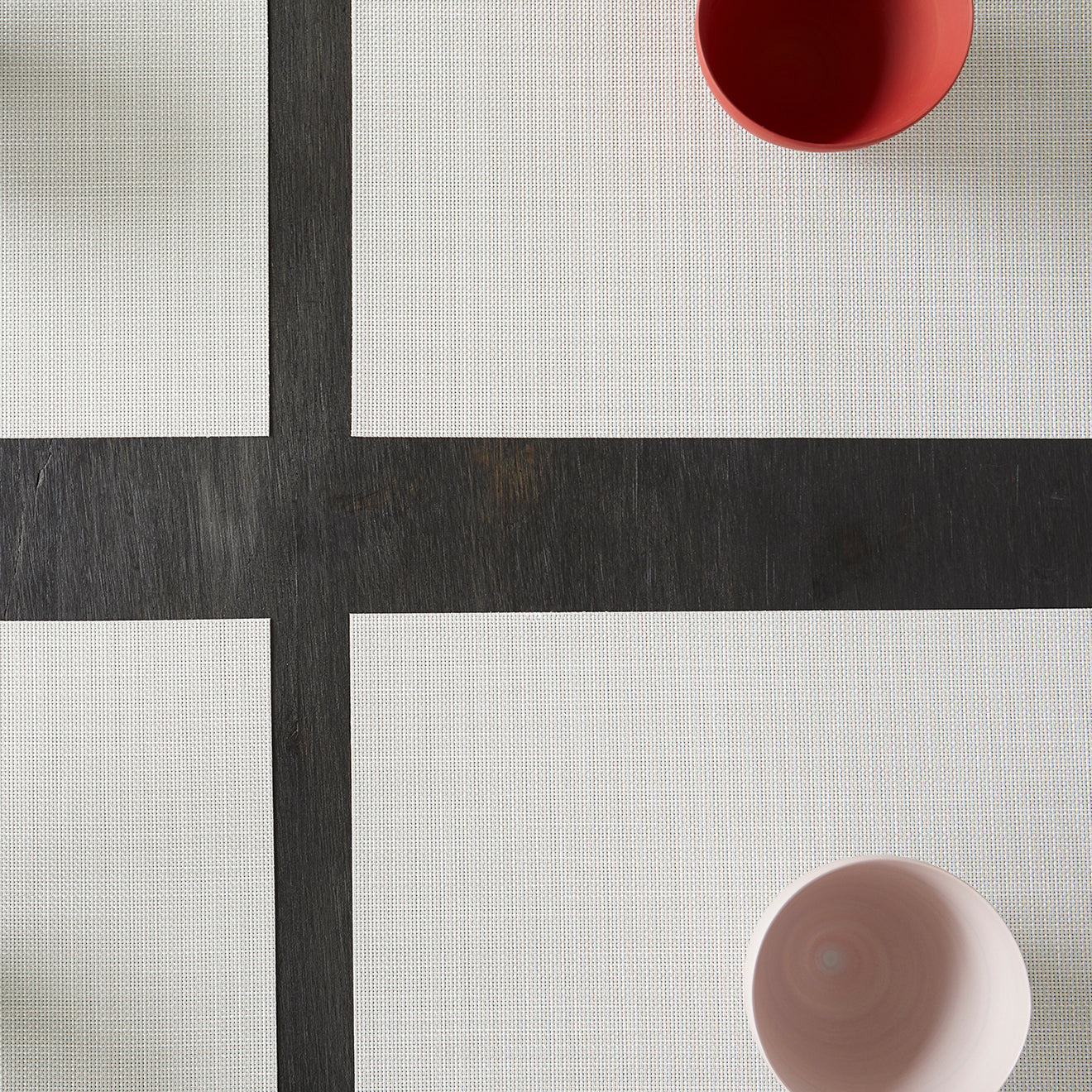 Chilewich Basketweave floor mat in Sandstone, showcasing woven terrastrand yarn texture and modern design aesthetic.