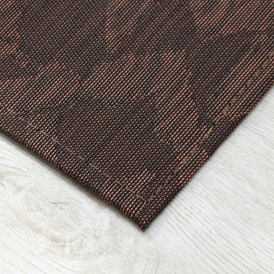 Cider Woven Floor Mat Detail in Mix of Dark Brown and Muted Red Orange Tones
