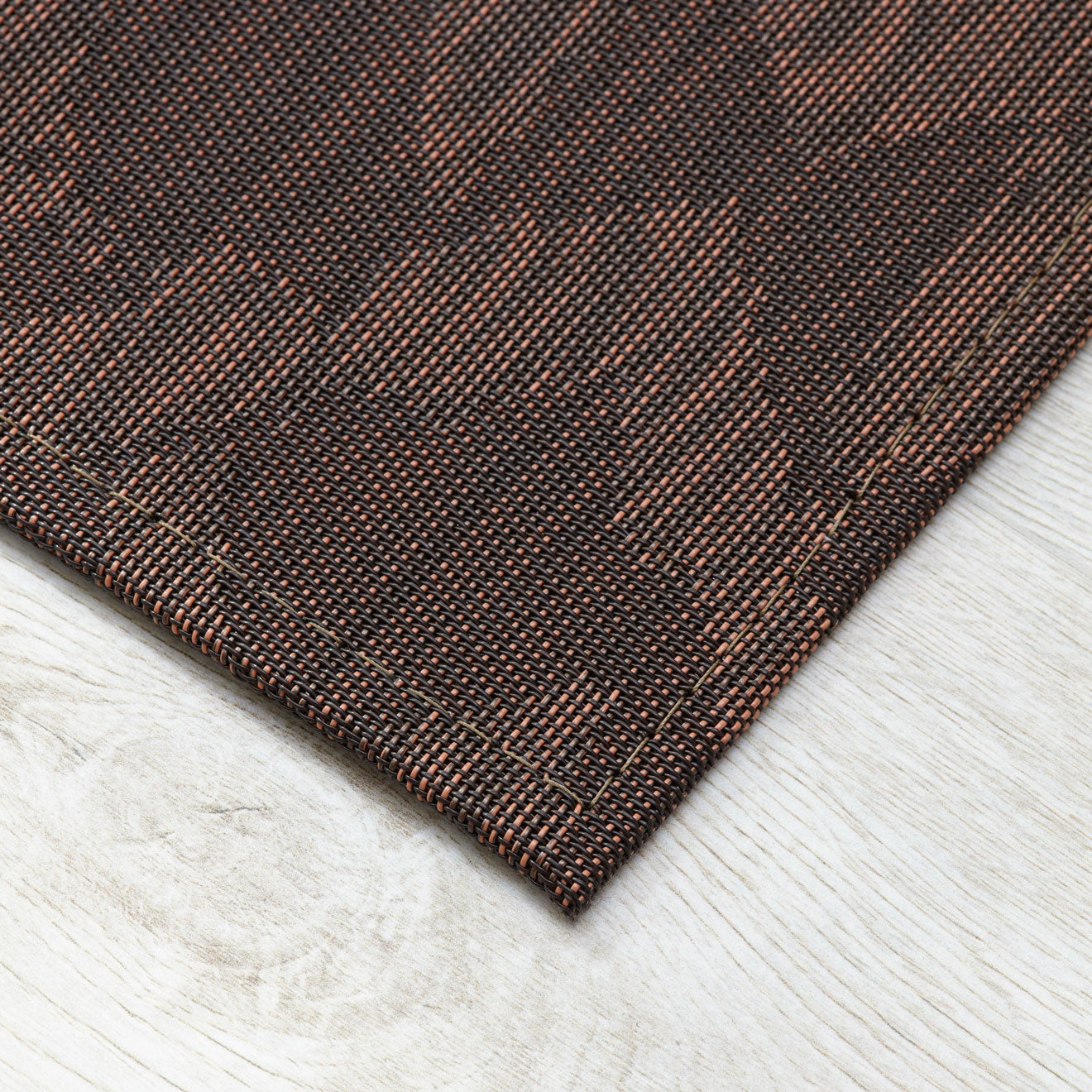 Cider Woven Floor Mat Detail in Mix of Dark Brown and Muted Red Orange Tones