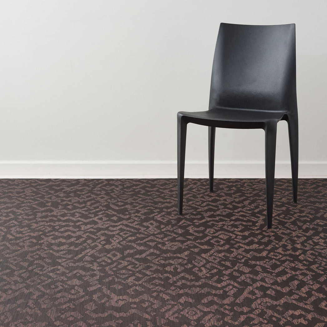 Cider Woven Floor Mat with Prop in Mix of Dark Brown and Muted Red Orange Tones