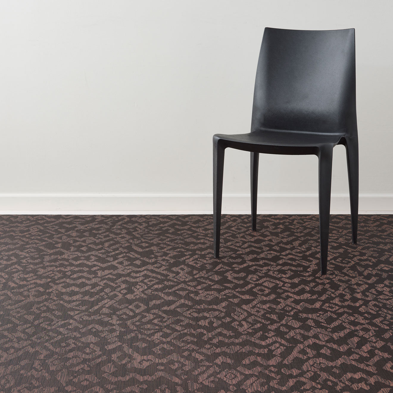 Cider Woven Floor Mat with Prop in Mix of Dark Brown and Muted Red Orange Tones