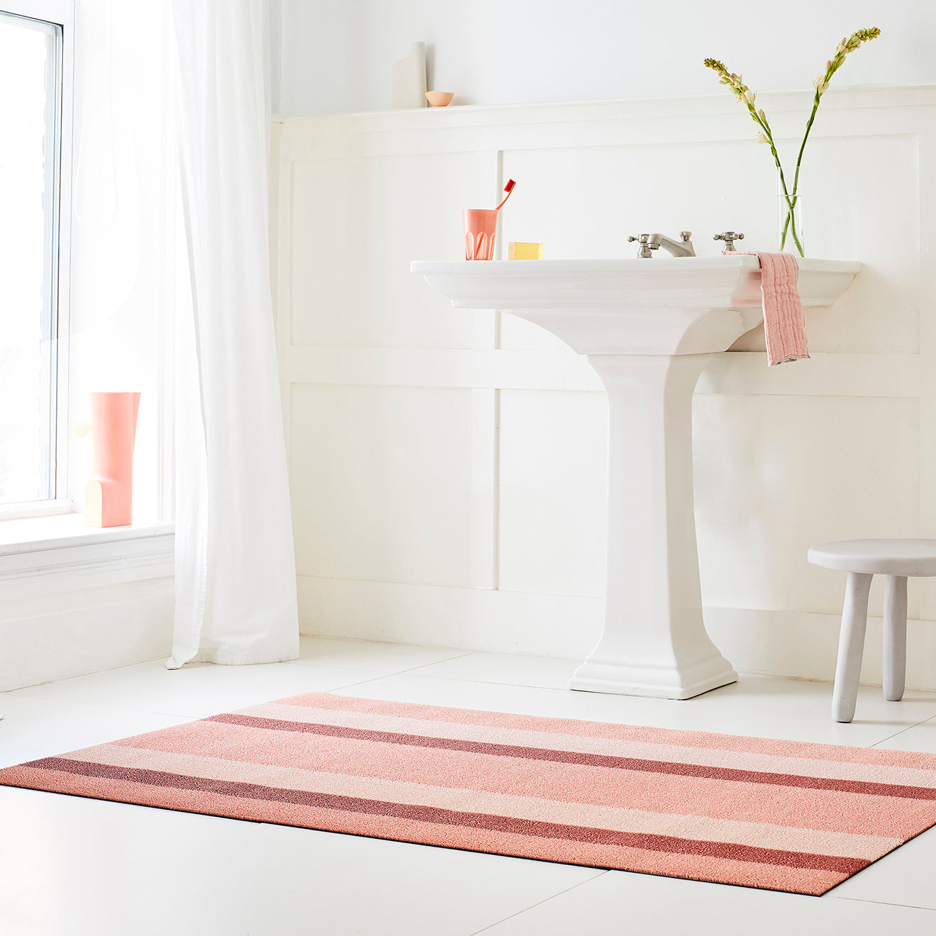 Chilewich striped woven mat with textured terrastrand yarn surface, featuring modern linear design and durable finish.
