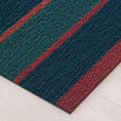 Chilewich striped woven mat with textured terrastrand yarn surface, featuring modern linear design and durable finish.