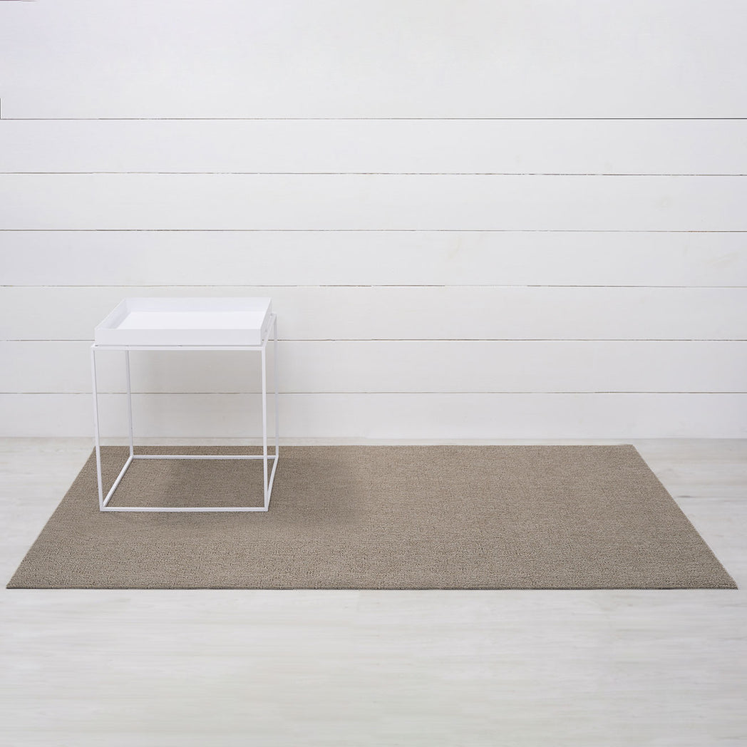 Chilewich woven floor mat in neutral woven terrastrand yarn, durable and stylish for modern living spaces.