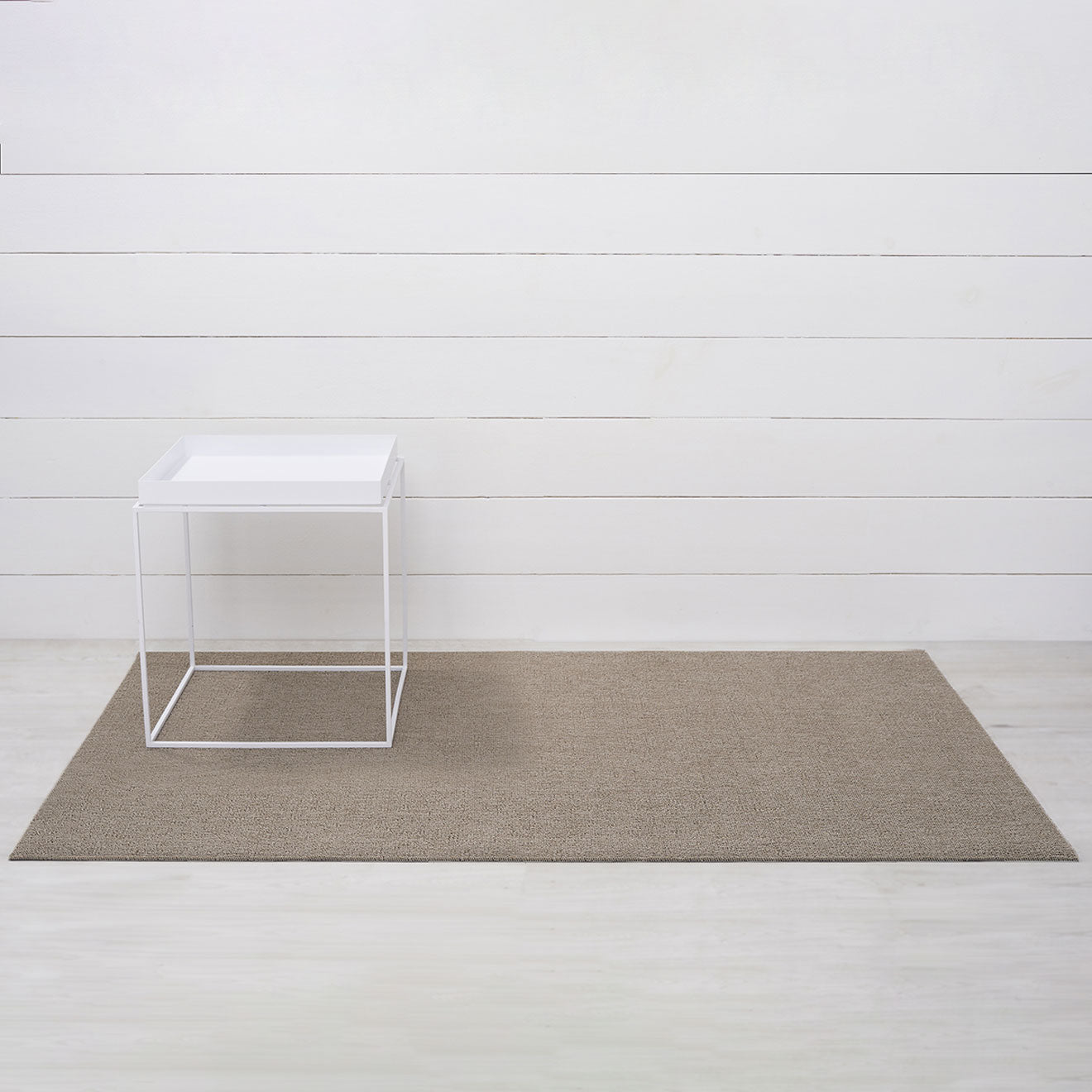 Chilewich woven floor mat in neutral woven terrastrand yarn, durable and stylish for modern living spaces.