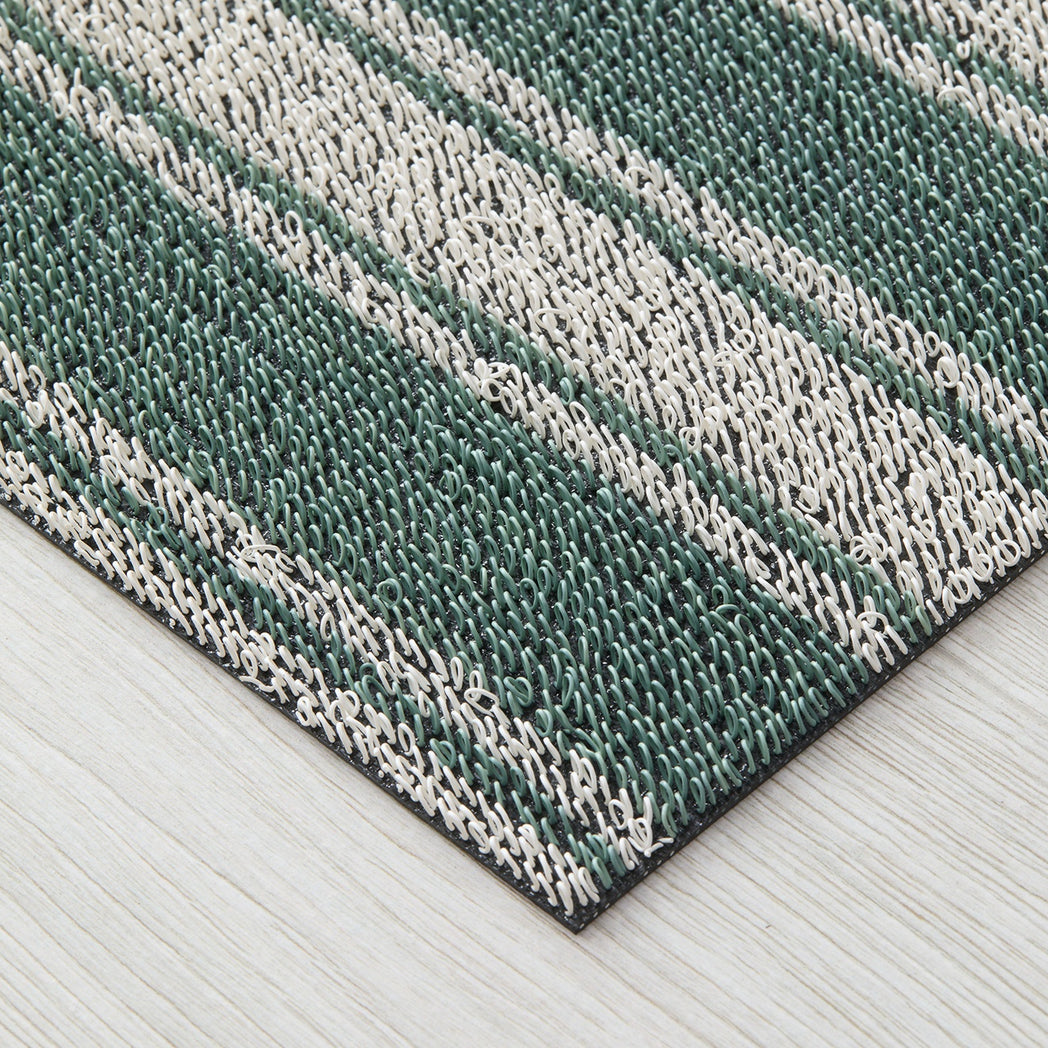 Chilewich striped woven mat with textured terrastrand yarn surface, featuring modern linear design and durable finish.