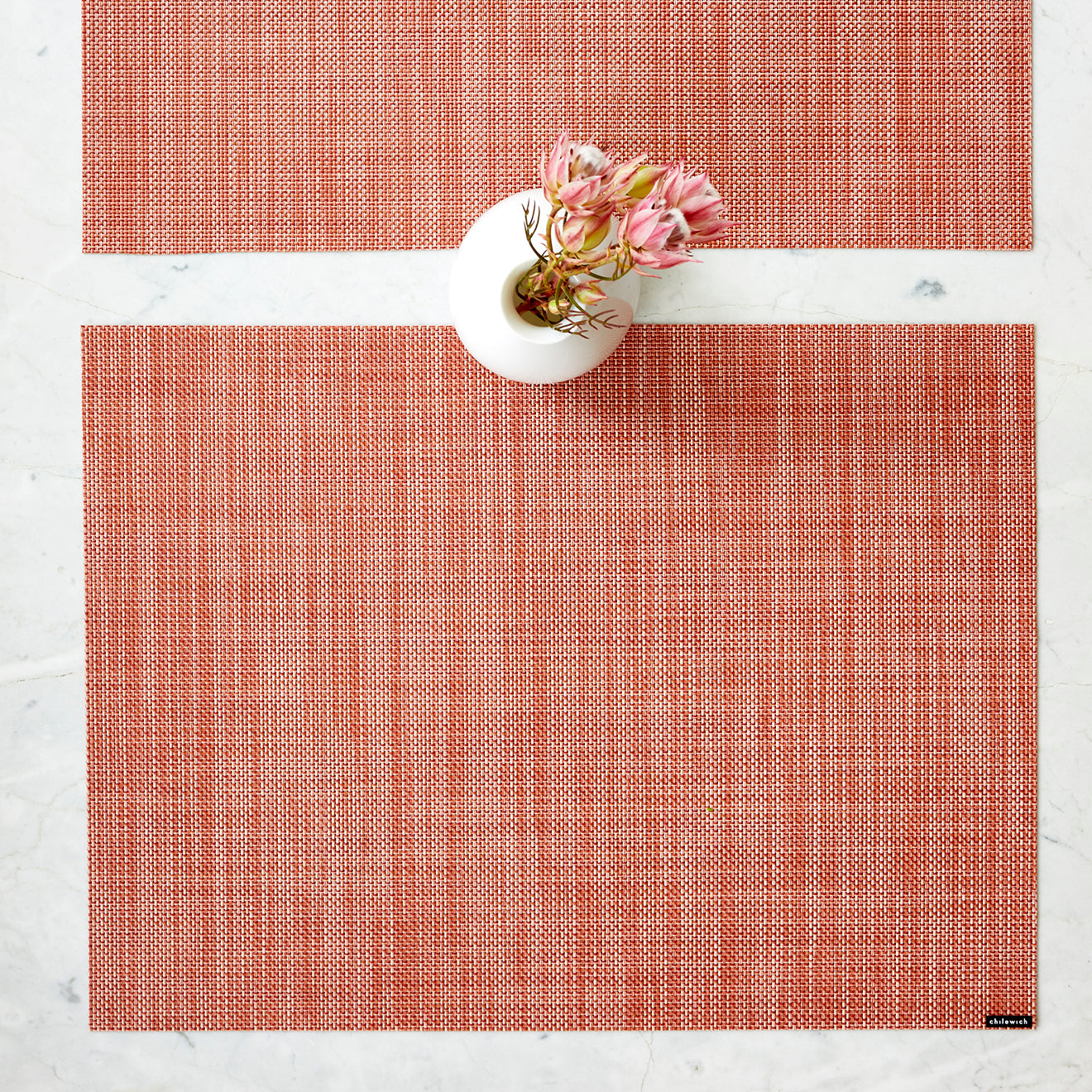 Chilewich Basketweave floor mat in clay, showcasing woven terrastrand yarn texture and modern design aesthetic.